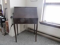 Desk closed showing exterior drawer and legs