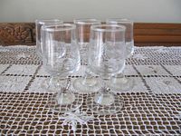 Cordial glasses grouped on lace table covering