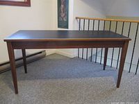 Full view of rectangular cherry table with black vinyl top