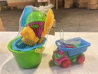 Both netted beach toy sets side by side