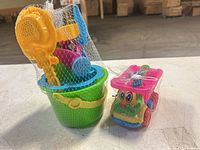overall view of one bucket set and one toy truck in mesh packaging