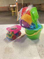 Two sealed beach toy sets showing bucket and truck