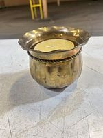 Front view showing fluted brass holder, rope detail, included candle