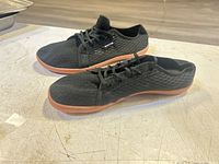 Side and top view of both sneakers showing mesh uppers and gum soles