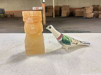 Onyx/agate tiki and ceramic bird whistle side by side, full view