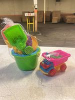 Bucket set and rolling car packaged in mesh, full view