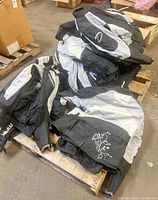 Pile of black and gray Daymak jackets on pallet