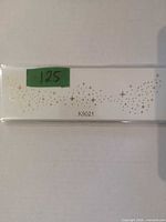 Sealed pack showing gold star/confetti sticker sheet design and code K9021