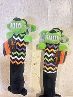 Two identical Multipet plush dog toys laid side by side