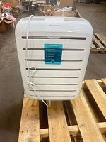 Front view showing vents, brand badge and hanging power cord