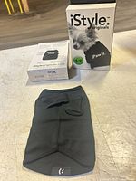 Dog shirt laid flat with two retail boxes