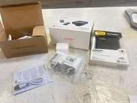 Overview of all items: Godox Magic XT1 kit, OtterBox case, C7 cord box, two USB chargers, cable and paperwork