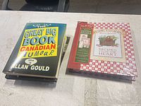 Stack showing humour book and sealed recipe binder