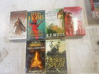 Group shot of six of the seven fantasy paperbacks showing covers and condition