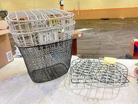 White wire basket nested in black mesh basket beside mounting plate