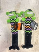 Two full-length plush dog toys showing overall design and size