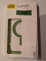 Front of sealed OtterBox Lumen Series iPhone 15 case packaging showing product through window