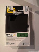 Front of retail box showing OtterBox Defender case, Drop+ 5x tested, Galaxy S24+ compatibility label