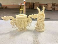 Pair of resin carvings side by side on work surface