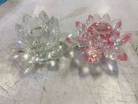clear and pink crystal lotus candle holders side by side