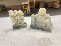 Both jade sculptures side by side on table