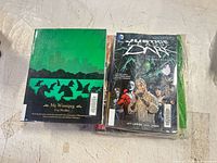 Back cover of My Winnipeg and front cover of Justice League Dark Volume One.