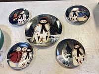 Five plates arranged around central plate on table