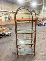 Full front view of rattan etagere showing four glass shelves