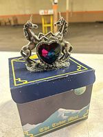 Front view showing two pewter unicorns and heart crystal on Tudor Mint box
