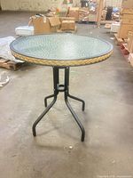 Full view of table showing glass top, frame and base