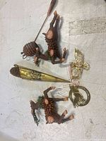 All items laid out: two reindeer, brass cone, dove ring ornament, angel ornament, pinecone pick