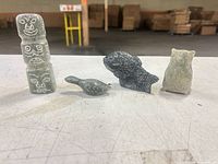 All four soapstone figurines lined up on tabletop