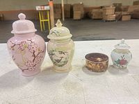 Front view of all four porcelain pieces showing shapes, colours and designs