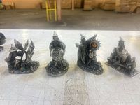 Front view of all four pewter wizard figurines