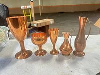 Front view of all five copper pieces