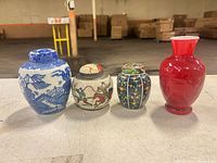 Four small vases/jars lined up