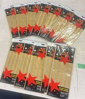 All 12 sealed packs of Sparkle gold striped tissue paper displayed