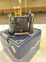 Figurine on top of original blue box showing overall composition