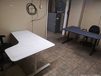 Both desks and one chair visible in room for scale and style