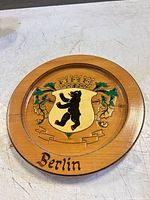 Front view of round wood Berlin coat of arms plaque