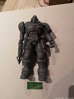 Front view of unpainted Warhammer Space Marine figure with rifle accessory