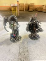 Front view of both pewter-style figurines on table