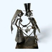 Front view of bride and groom welded metal sculpture on square base