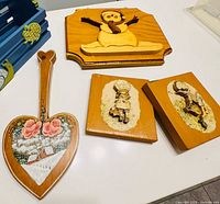 Overall view of four wooden wall hangings