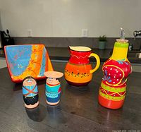 Group shot of all five hand-painted ceramic items on table