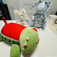 All three plush toys—Webkinz bride mouse, checkered bunny, watermelon cow—group shot