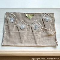 Full packaged set showing four placemats and folded napkins with lace applique