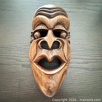 Front view showing full carved mask detail