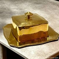 lidded butter dish on plate, front angle