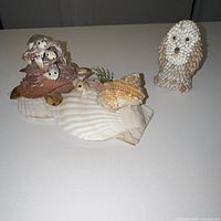 Both seashell sculptures displayed together